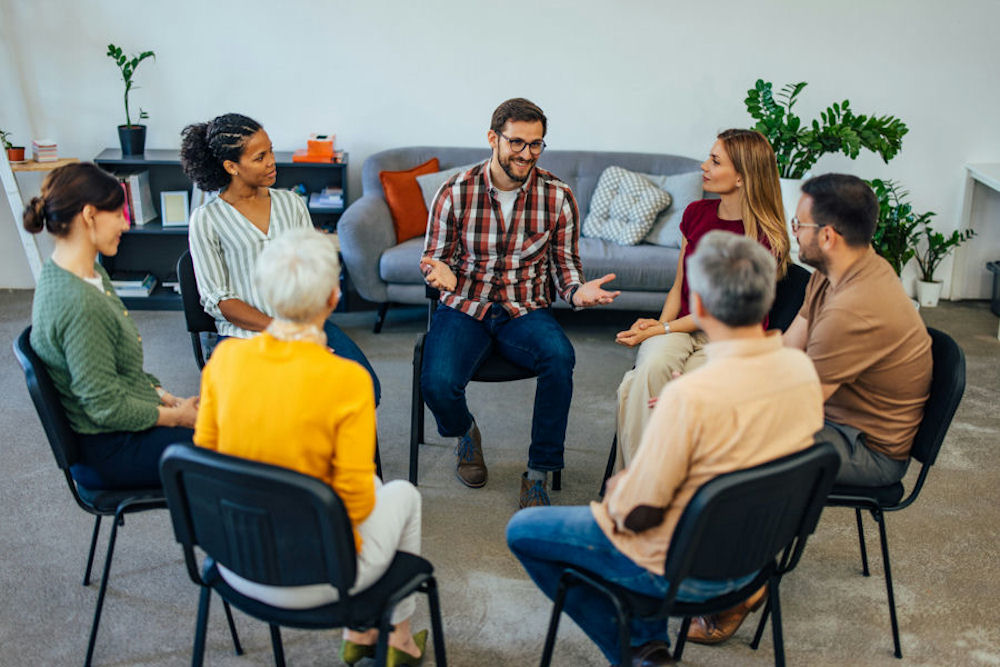 a-man-speaking-up-during-an-aa-meeting