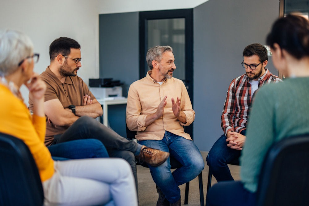 an instructor speaking to individuals in therapy