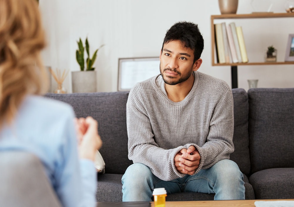 Individual discussing how long opioids stay in the system with a therapist during addiction treatment.